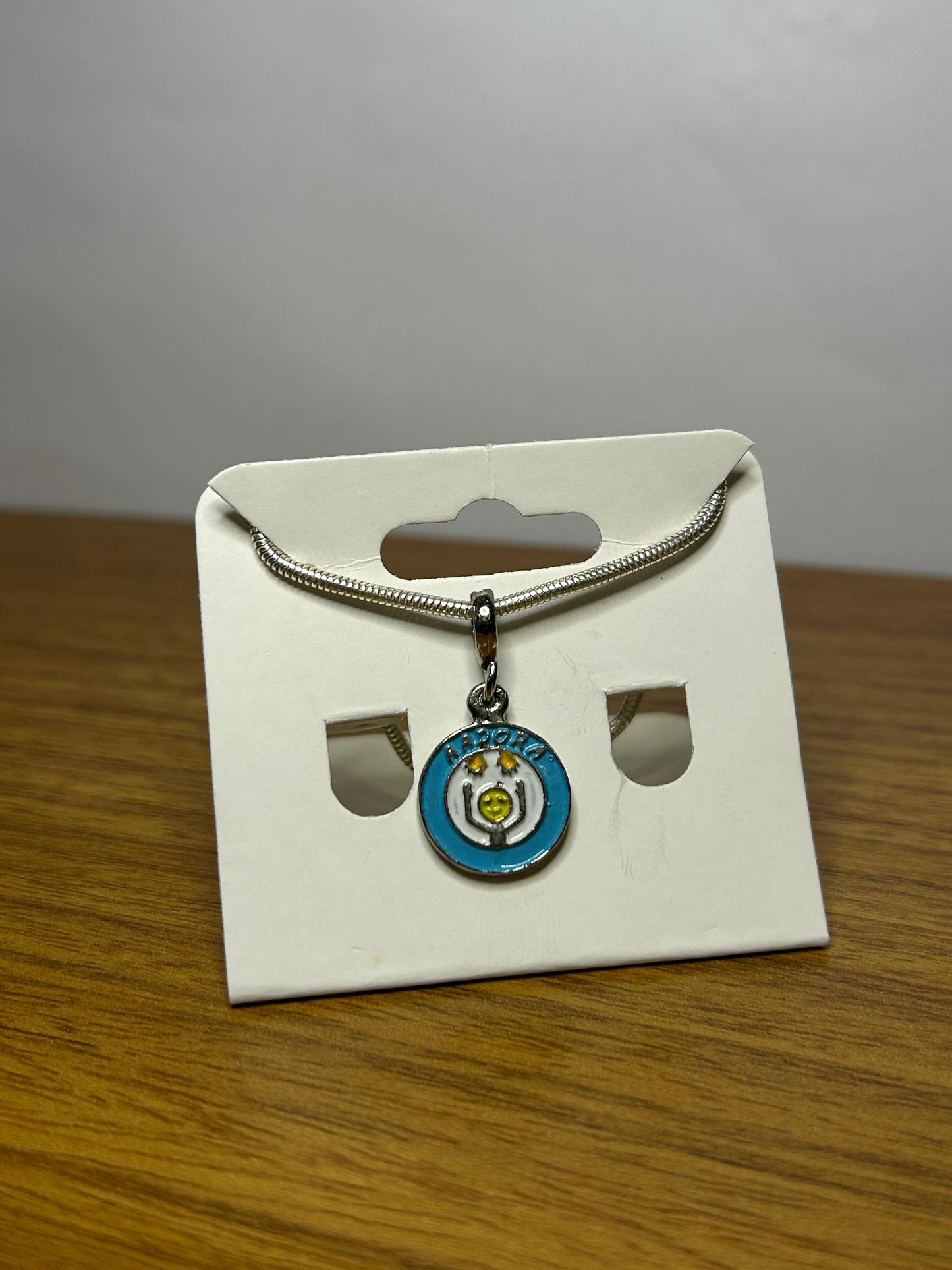 Berloque Símbolo da Aadora - Apoio às Pessoas com Doenças Raras